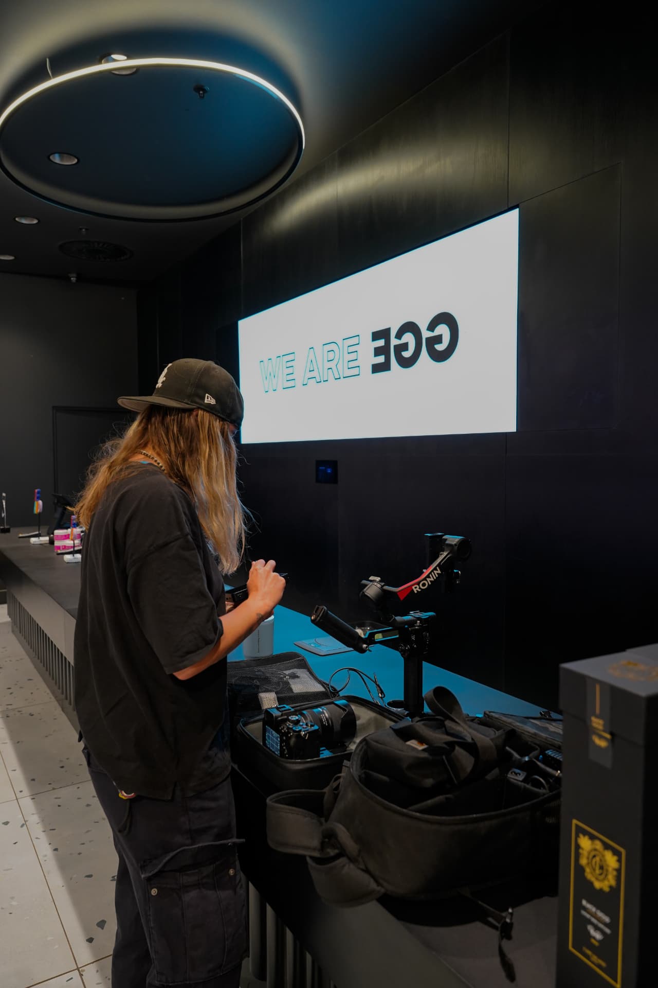 Videographer preparing camera equipment on location